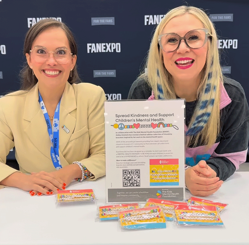 Ashley Eckstein and Dr. Ariana Hoet promote mental health awareness at FAN EXPO, showcasing a Kids Mental Health Foundation collaboration featuring colorful friendship bracelets designed to spread kindness and support children’s emotional well-being.