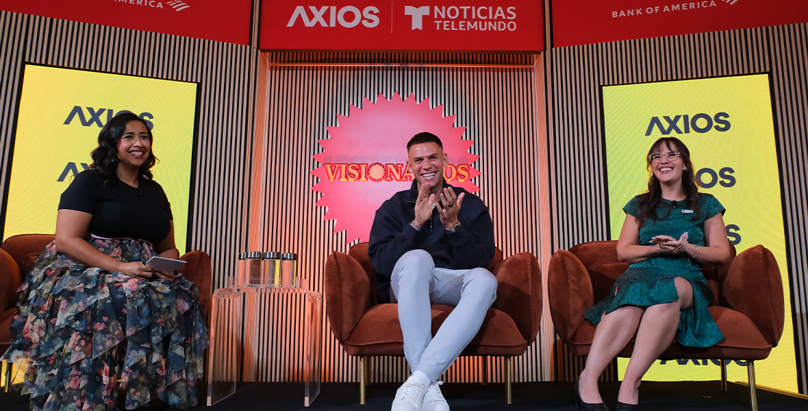 Christian Ramirez participates in an Axios and Telemundo Visionarios panel, smiling alongside fellow speakers during a discussion on community leadership and youth mental health advocacy.