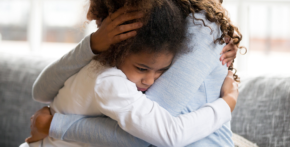 Young girl hugging her mother tightly, seeking comfort and emotional support. Highlighting the impact of grief, trauma, and the importance of parental reassurance in children's mental health.