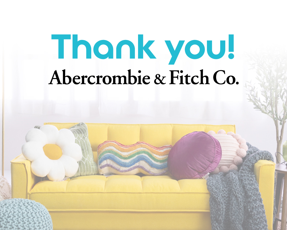Thank you graphic for Abercrombie & Fitch Co. from The Kids Mental Health Foundation, featuring a cozy yellow couch with decorative pillows, including a rainbow, daisy, and textured knit designs.