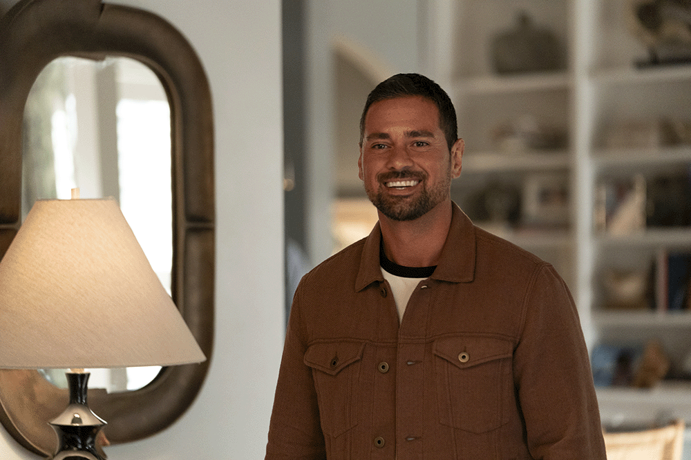 Man smiling inside a home in a scene from “It’s Not Like That,” a Wonder Project series focused on family relationships and mental health conversations
