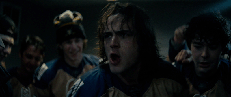 Shattered Ice film still showing high school hockey players on the ice, highlighting themes of teen mental health, grief, friendship, and emotional support.