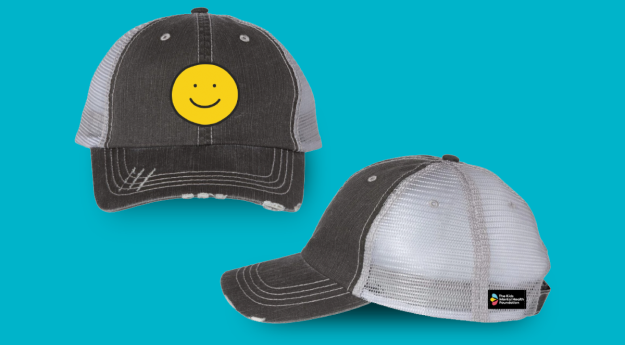 A black baseball cap with a smiley face